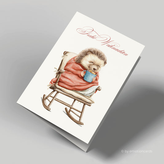 Weihnachtskarte | Igel mit Decke und heißer Schokolade auf Schaukelstuhl